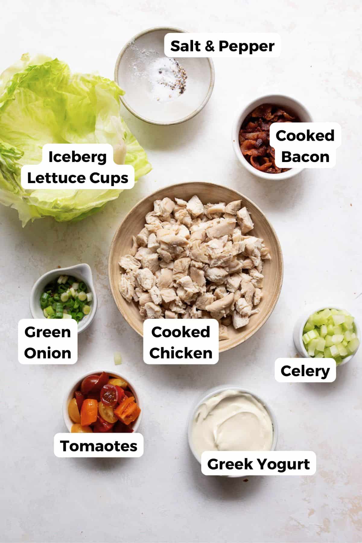 Ingredients for BLT chicken salad including cooked chicken, bacon, grape tomatoes, celery, green onion, and Greek yogurt.