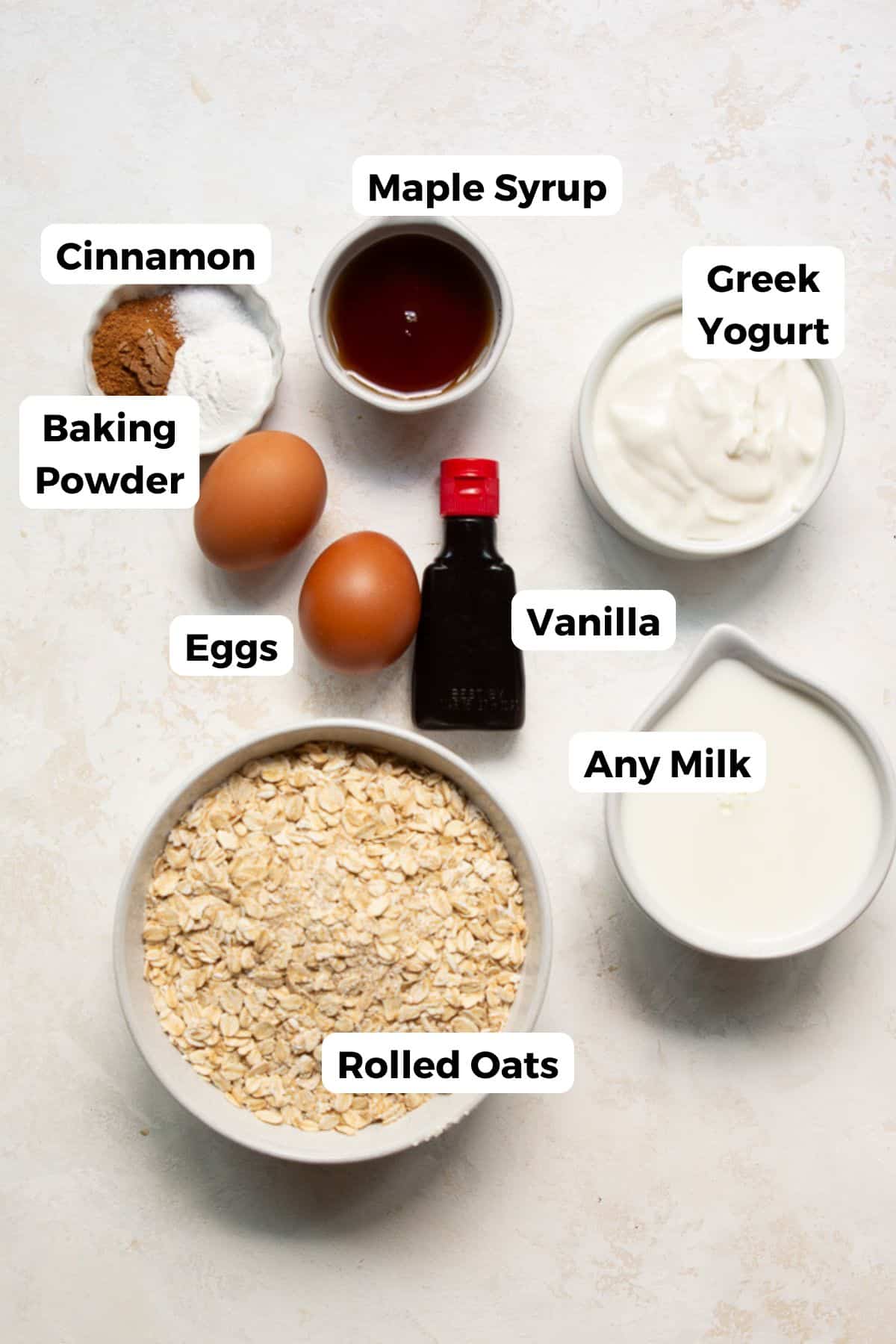 Ingredients for protein oatmeal blender pancakes including rolled oats, Greek yogurt, eggs, maple syrup, and milk.