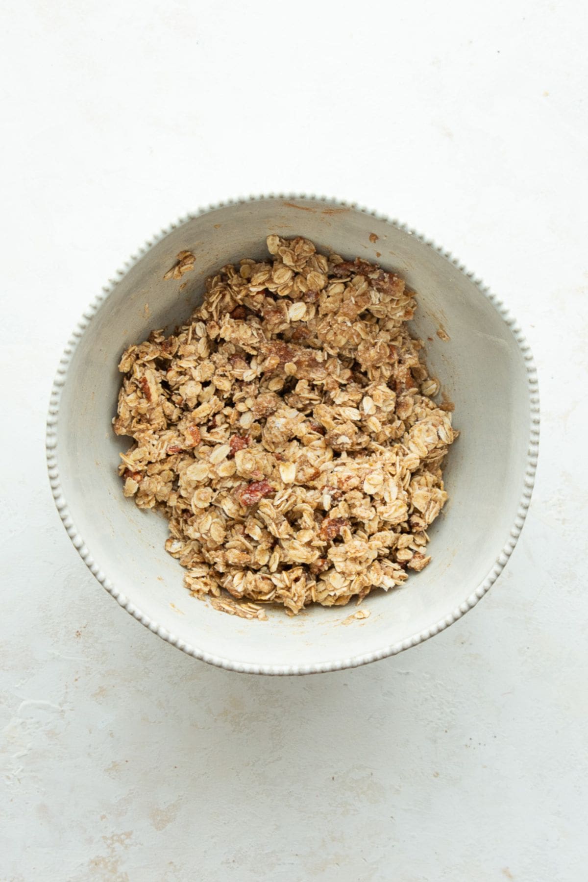 Almond flour oat crumble topping mixed together in a white bowl.