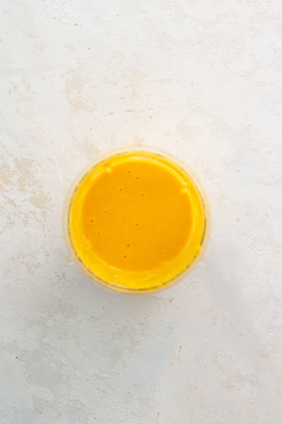 Smooth, bright orange carrot ginger dressing blended in a jar.