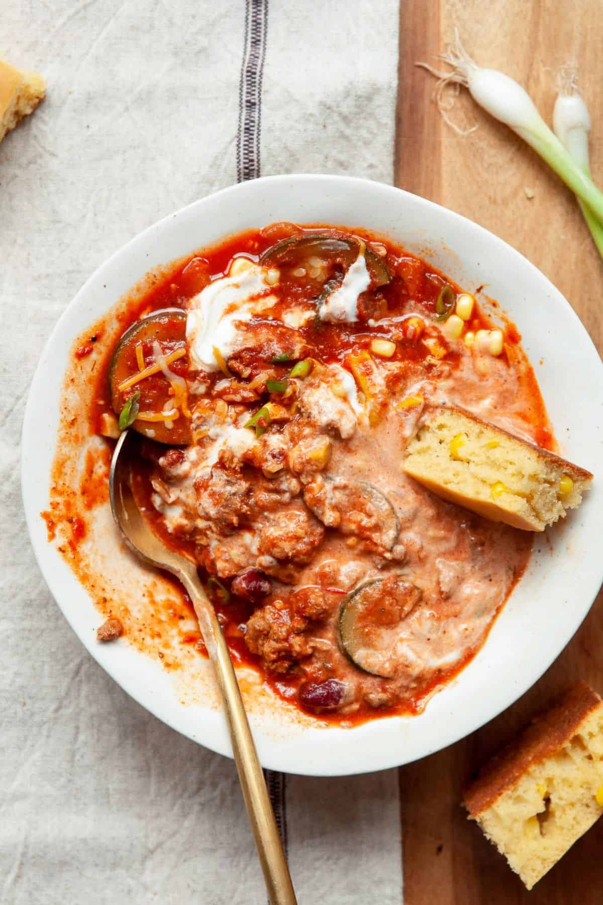 Healthy turkey chili served with a slice of gluten-free almond flour cornbread.