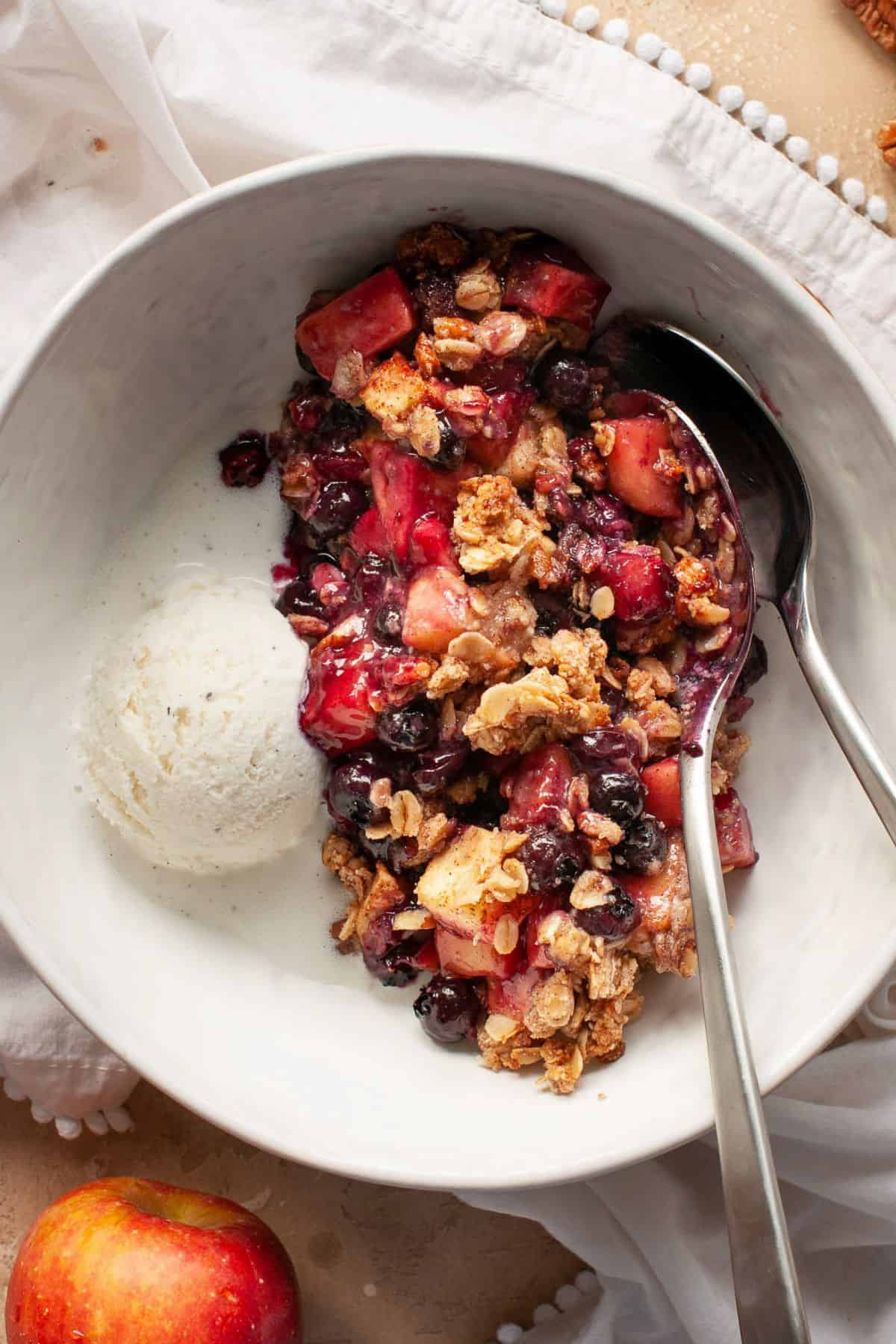 Gluten-free and vegan apple blueberry crisp with ice cream.