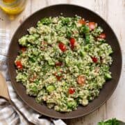 Mediterranean quinoa tabbouleh salad with parsley, mint, tomato, and cucumber.
