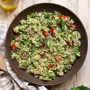 Mediterranean quinoa tabbouleh salad with parsley, mint, tomato, and cucumber.