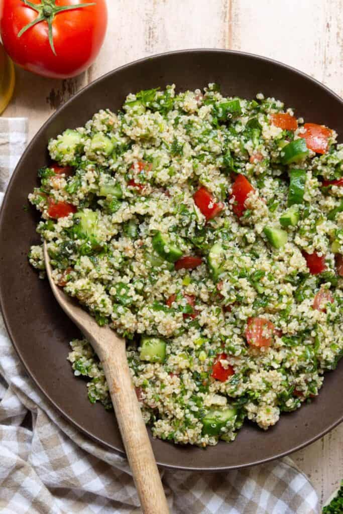 Gluten-free tabbouleh salad with quinoa, tomato, and cucumber.