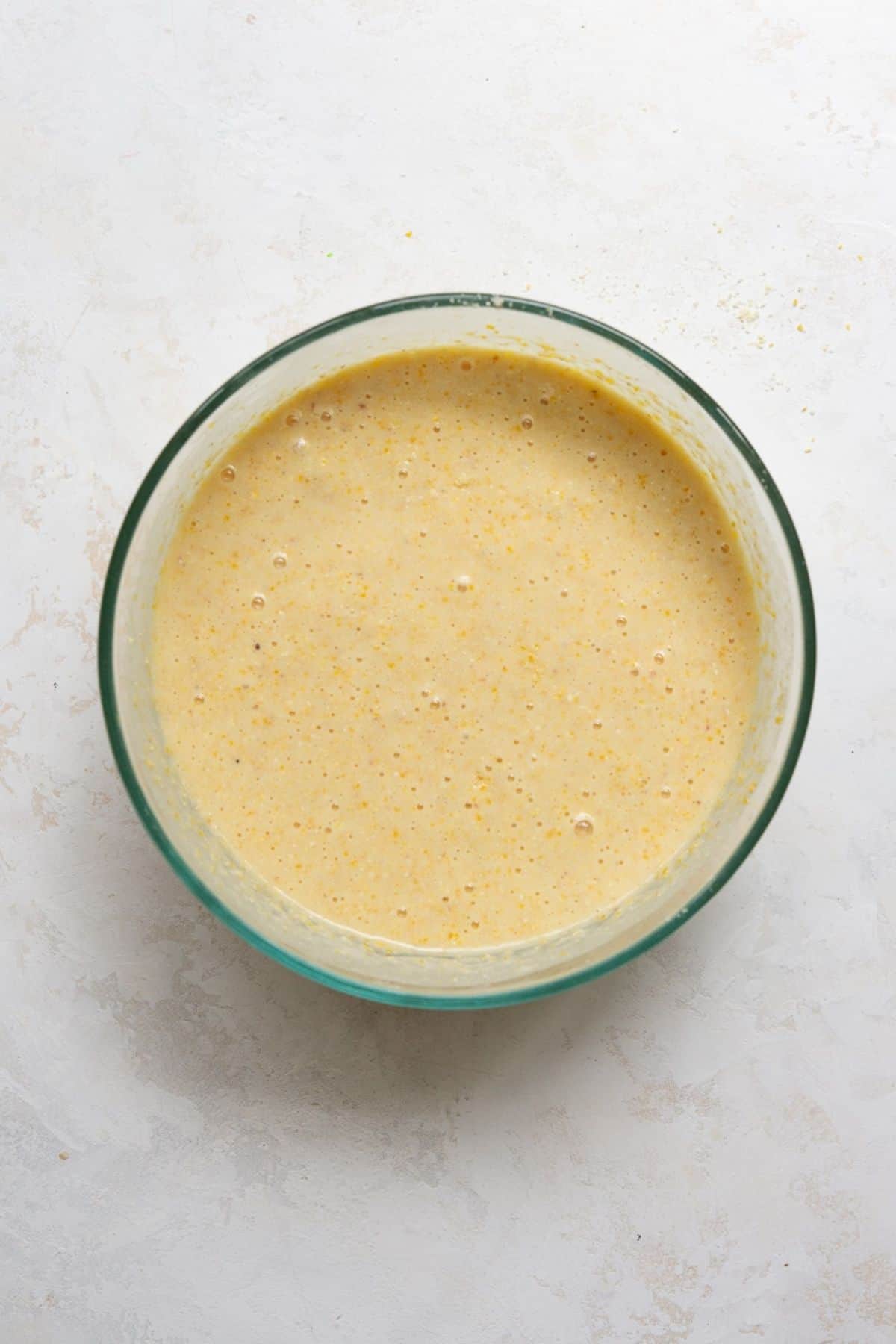 Almond flour cornbread batter mixed in a glass bowl.