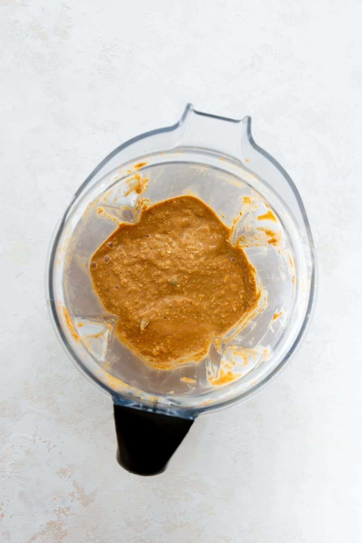Smooth blended pumpkin baked oats batter in a blender jar.