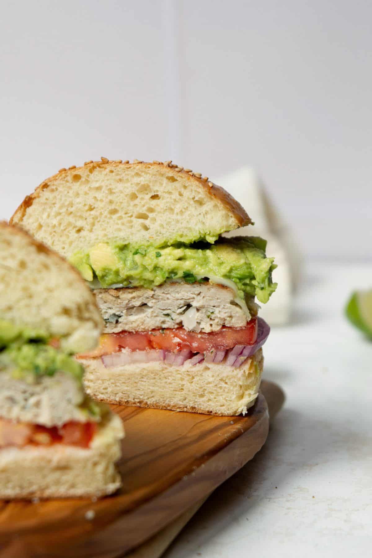 Cilantro lime chicken burger cut in half showing the juicy patty inside.