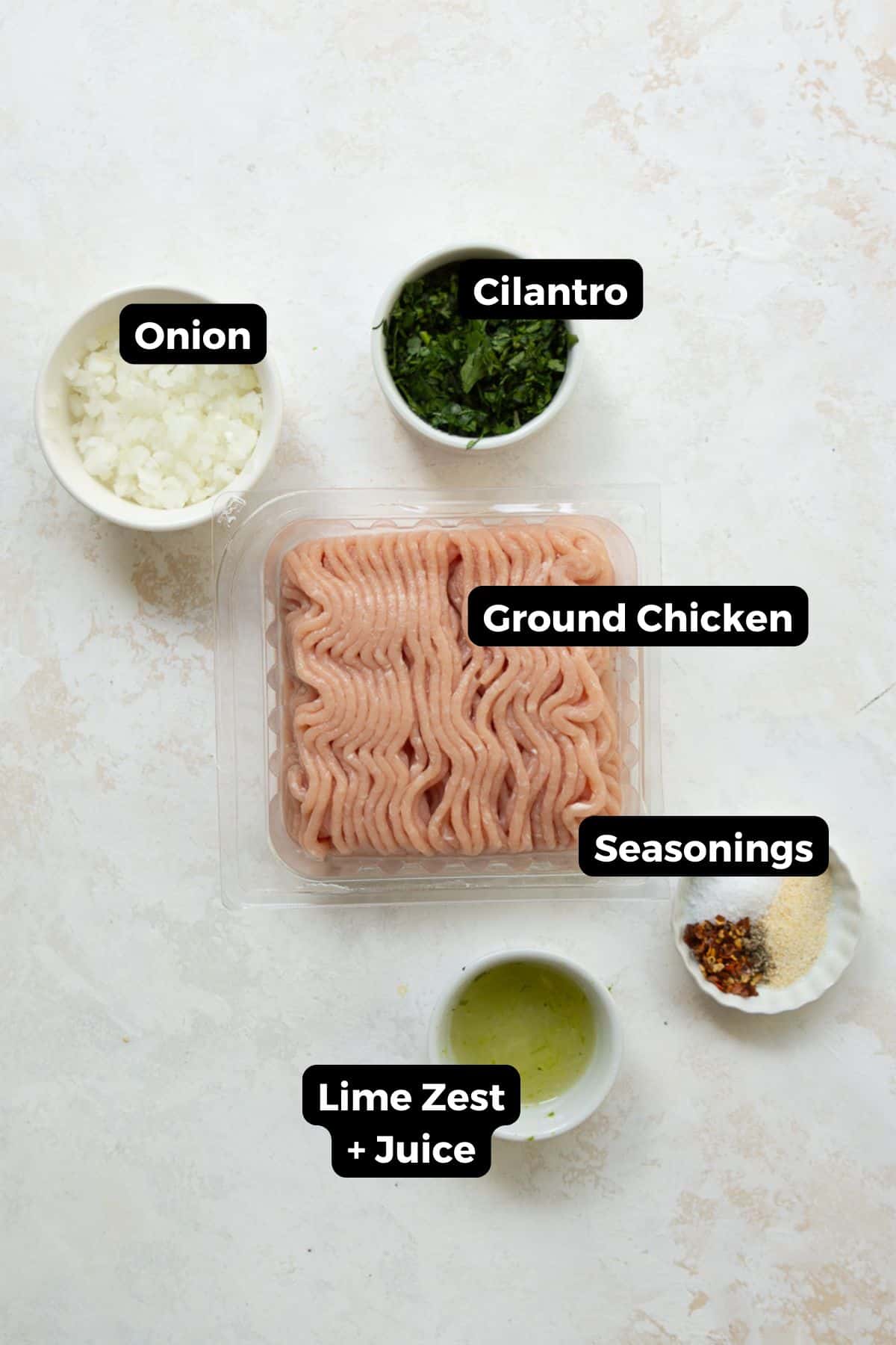 Labeled ingredients for cilantro lime chicken burgers including ground chicken, onion, cilantro, lime, and seasonings.