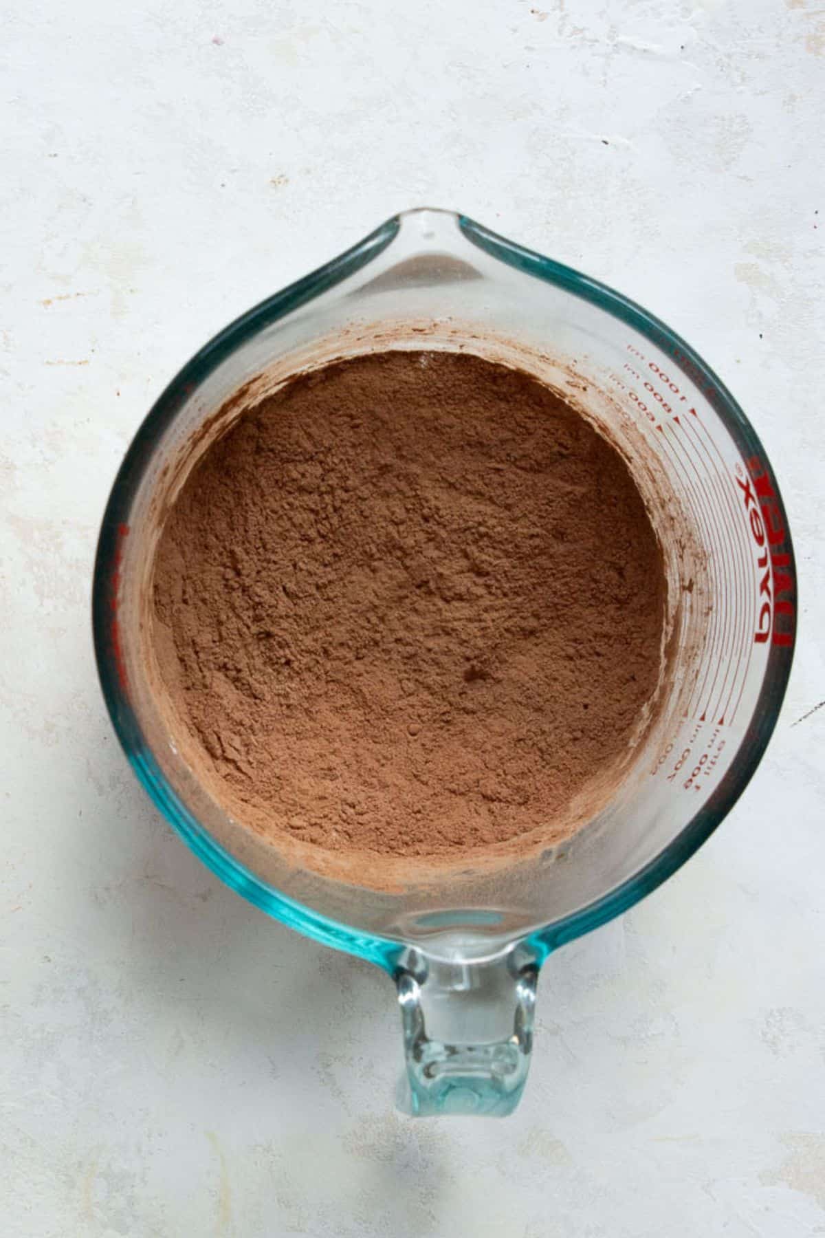 Cocoa powder, cornstarch, baking soda, and salt whisked together in a glass bowl.