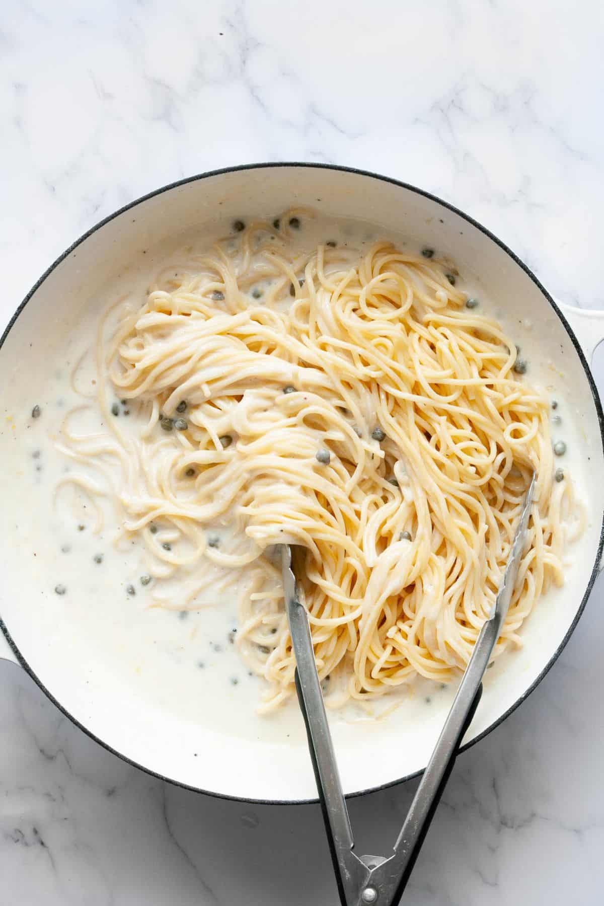 Creamy lemon caper pasta tossed in the pan with capers.