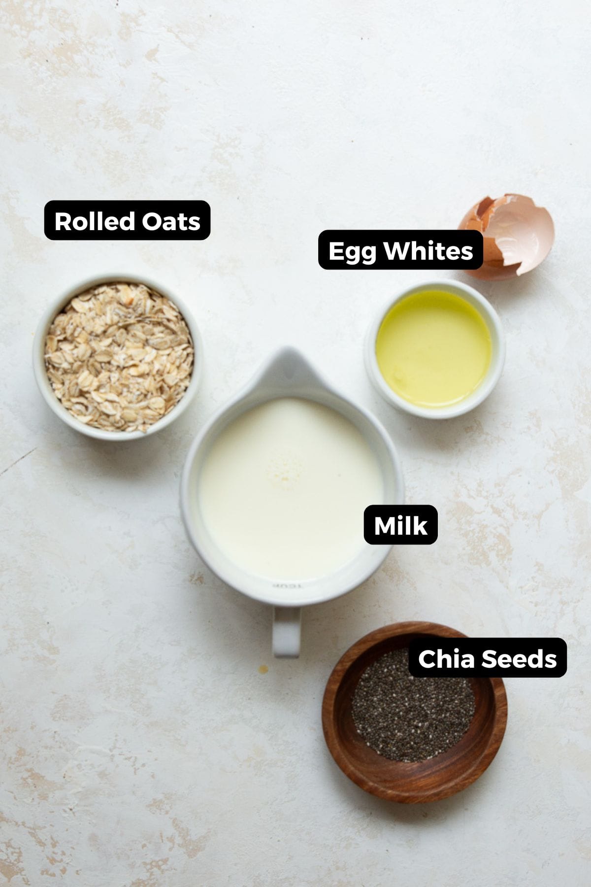 Labeled ingredients for egg white oatmeal: rolled oats, milk, egg whites, and chia seeds.