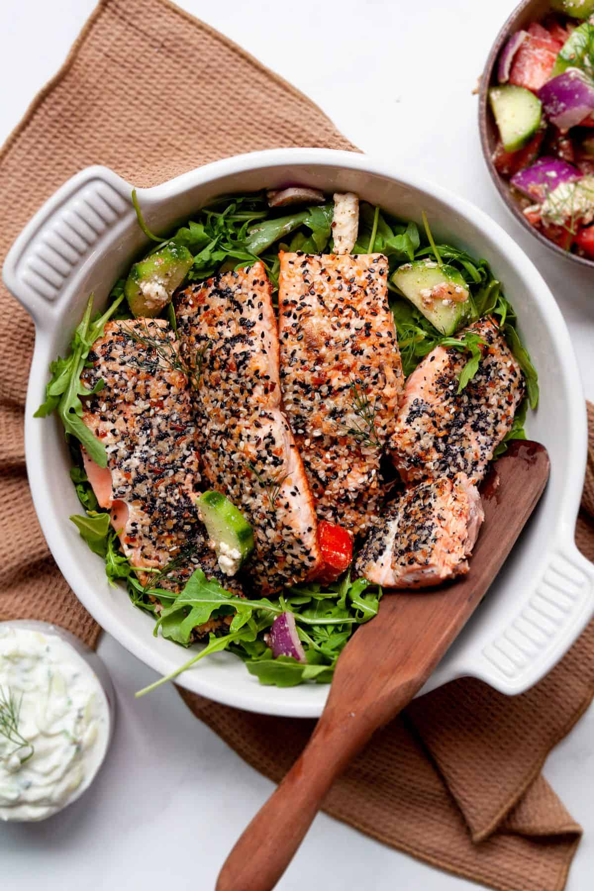 Everything bagel salmon sliced over greens.