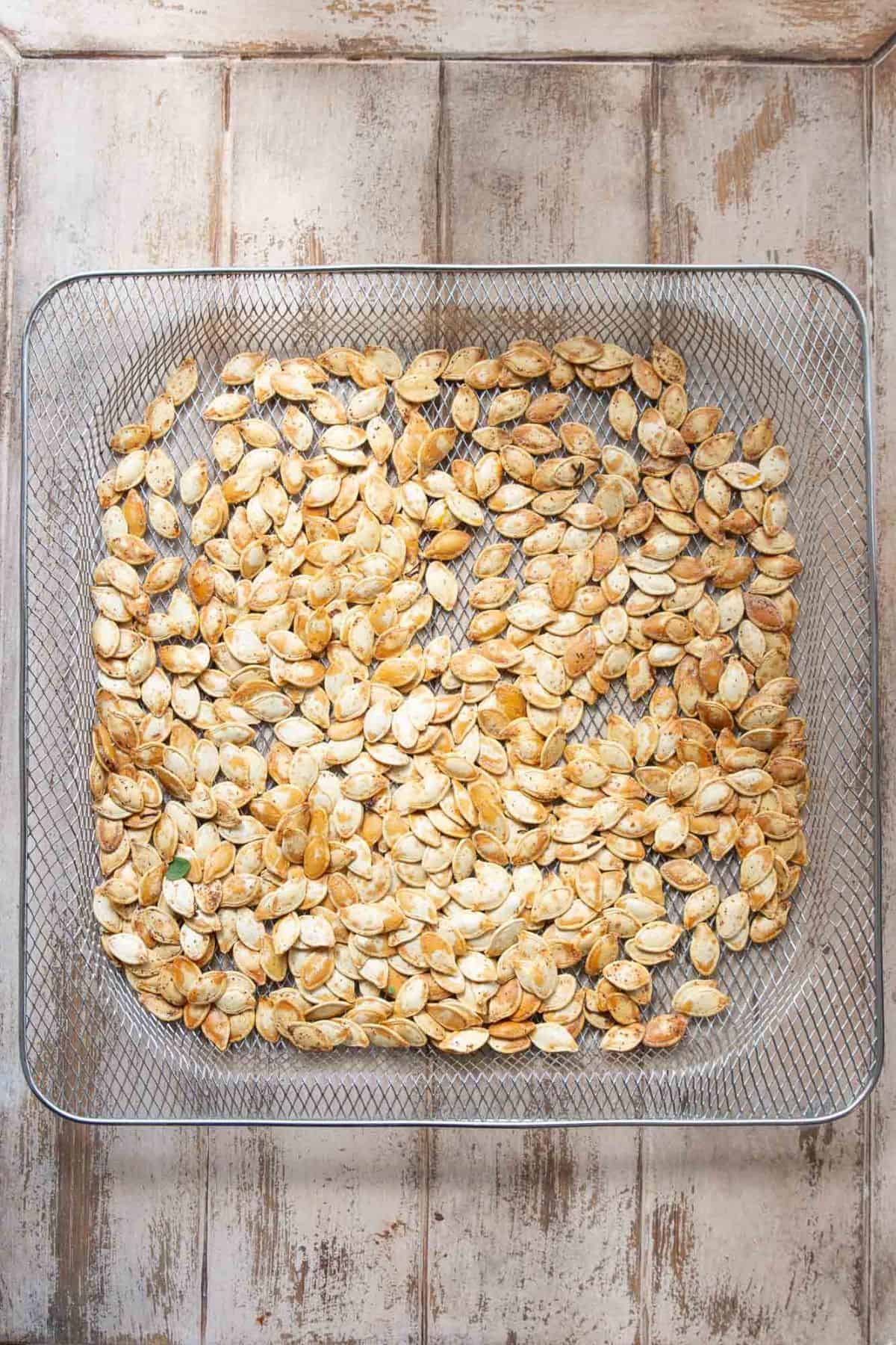 Golden crispy air fryer pumpkin seeds after the second air fry.