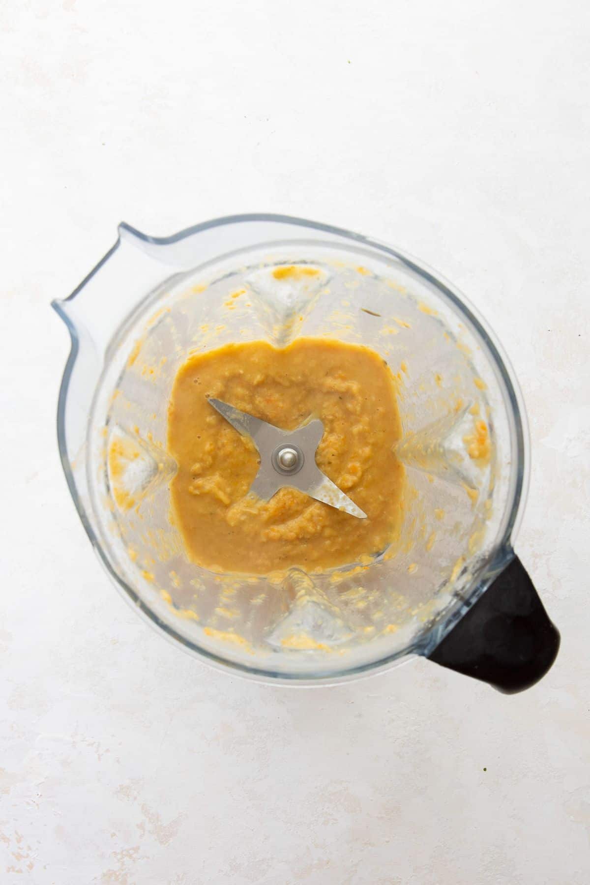 Blended chickpeas and broth in a blender to thicken the soup.