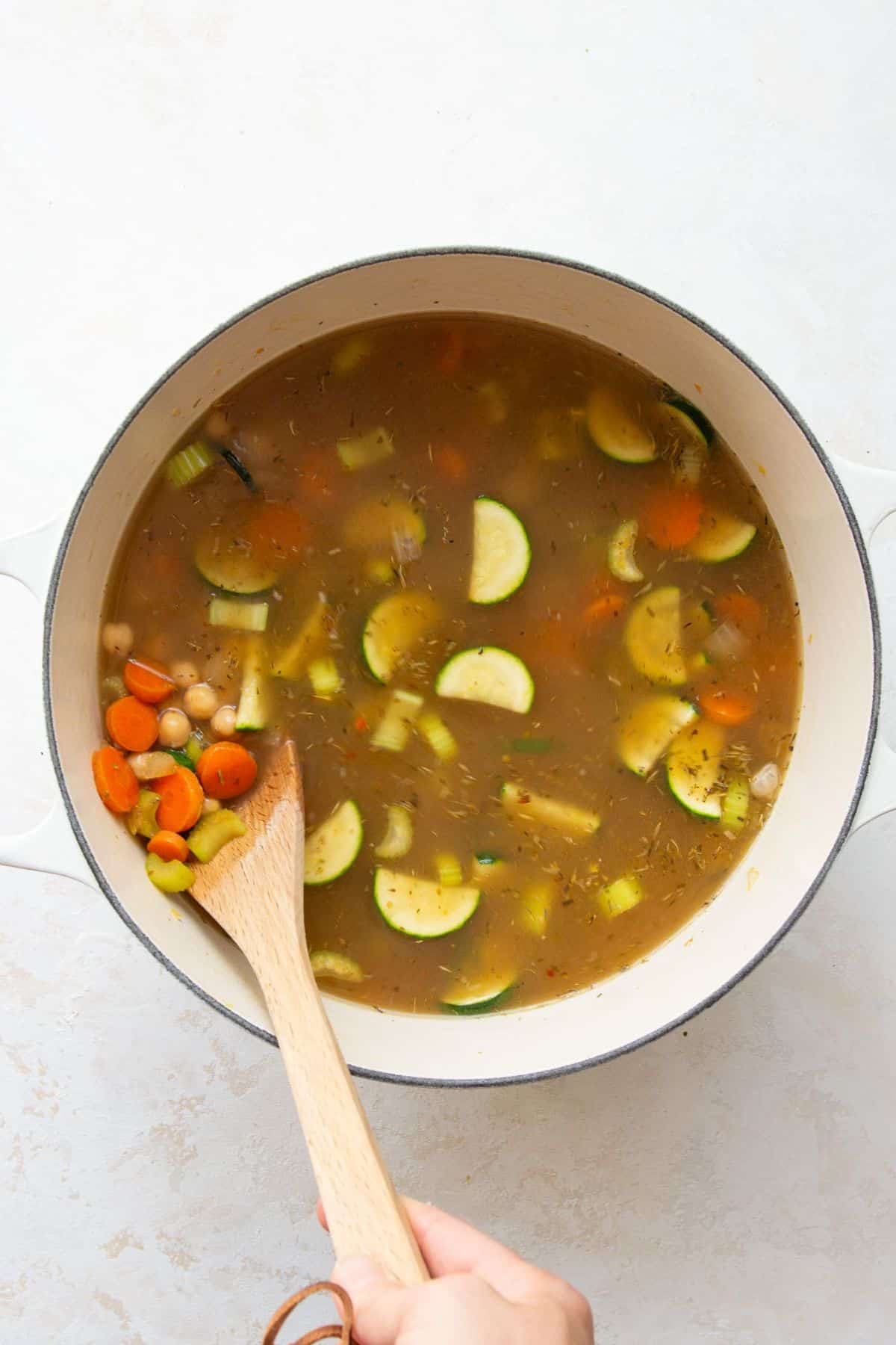 Greek chickpea soup simmering with broth and chickpeas in a pot