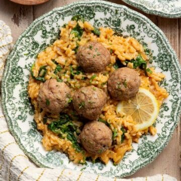 Juicy, gluten-free Greek turkey meatballs served over creamy lemon rice with spinach.