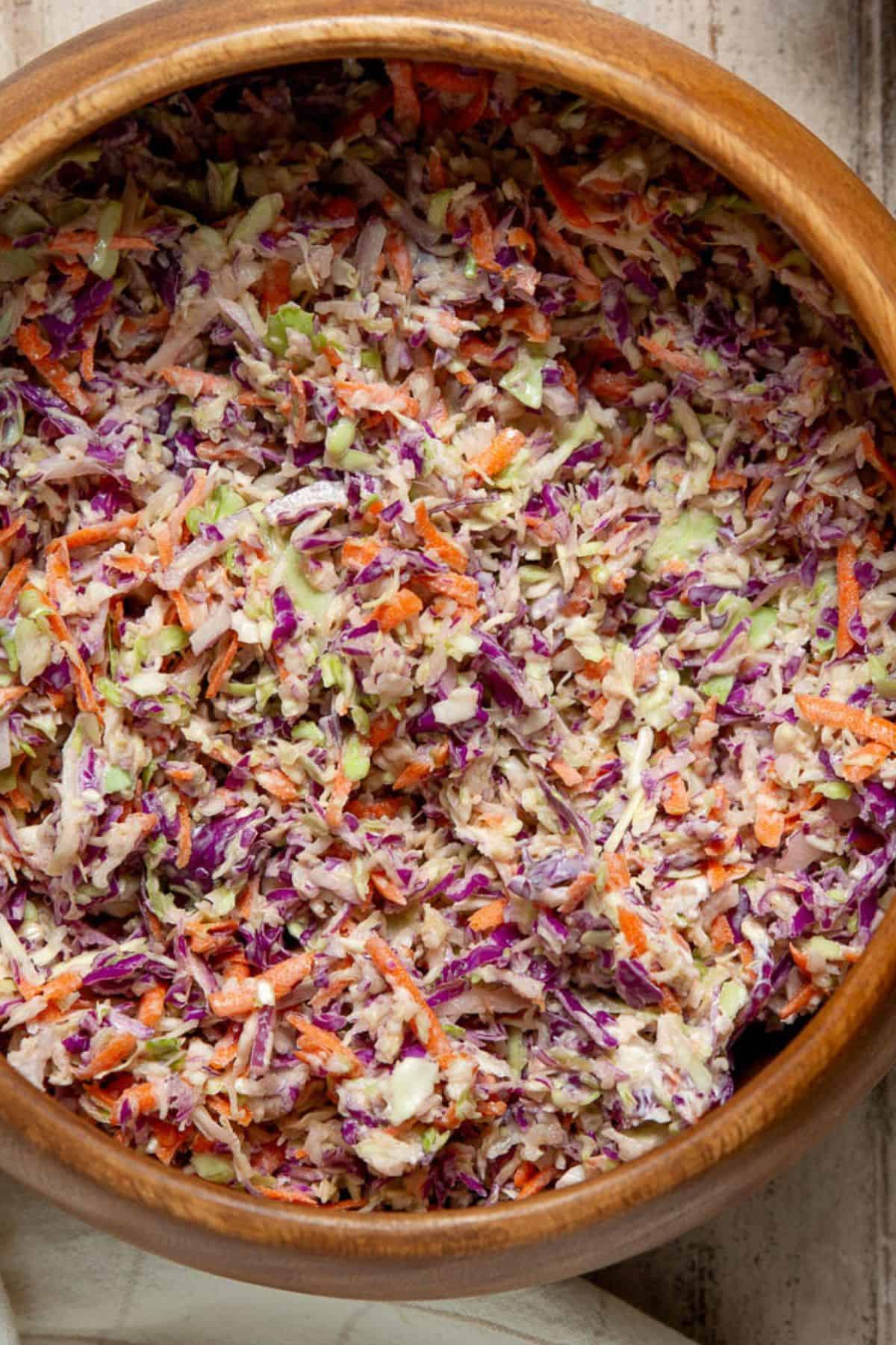 Healthy coleslaw tossed until every strand of cabbage and carrot is coated in the creamy dressing.