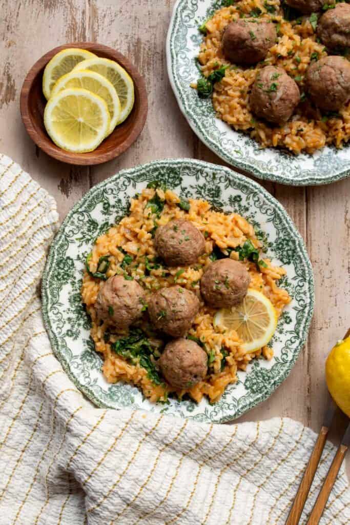 Two plates of Greek turkey meatballs with lemon rice.