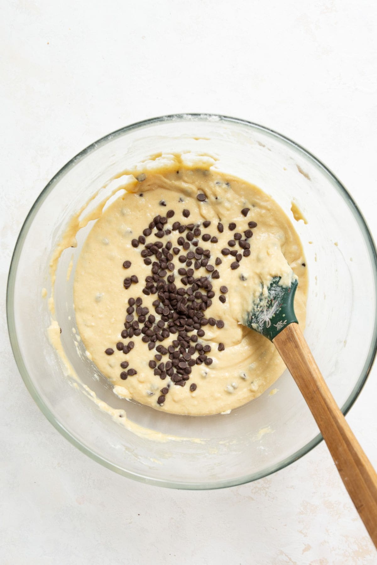 Adding mini chocolate chips to protein muffin batter.