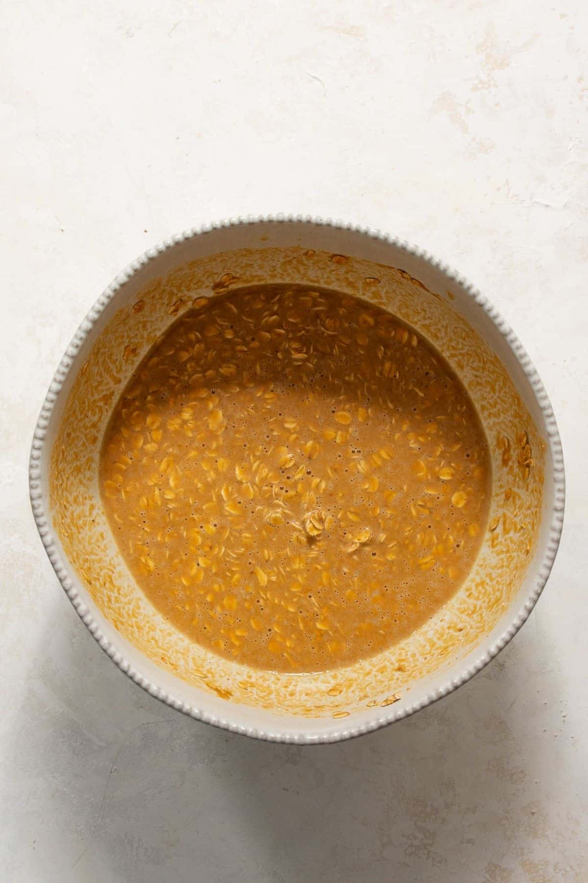 Whisked pumpkin baked oatmeal batter in a metal mixing bowl.