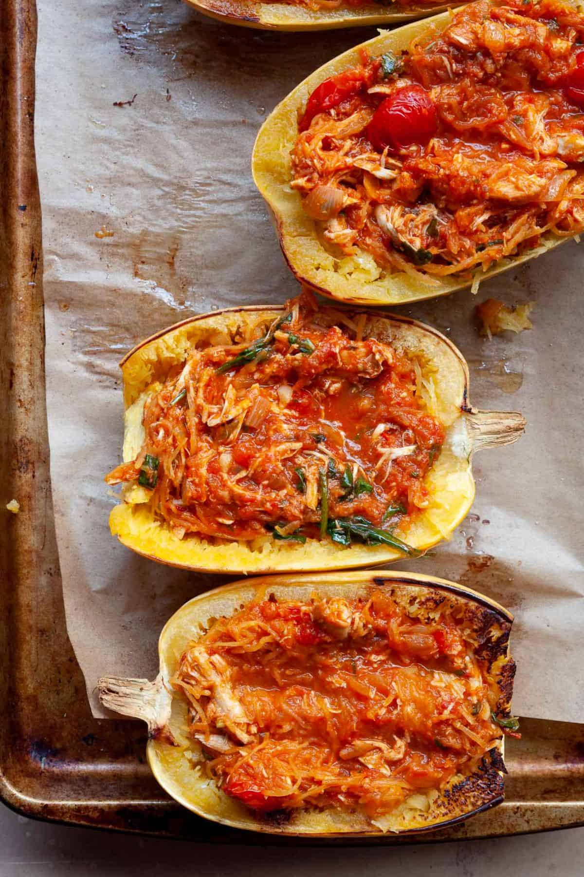 Spaghetti squash boats filled with chicken parmesan filling before adding cheese.