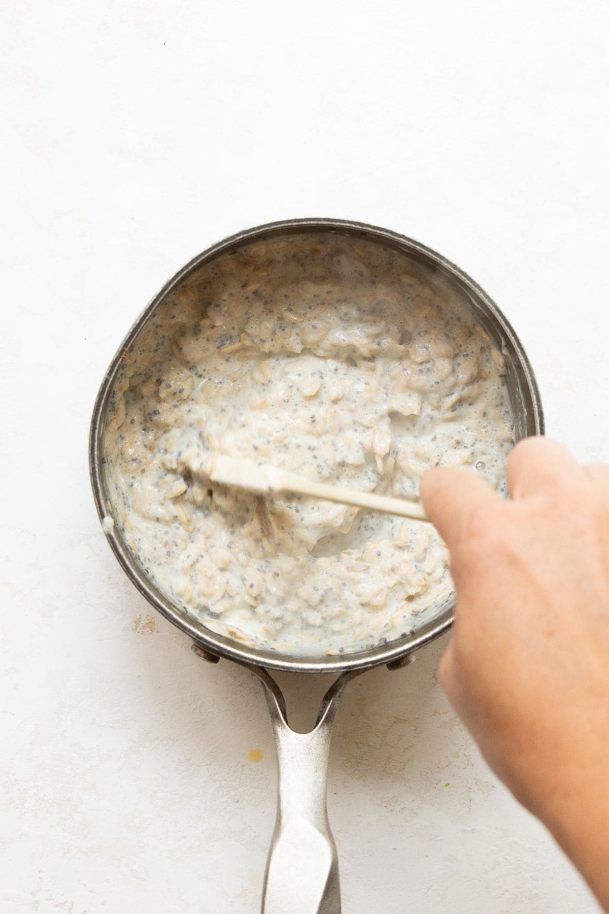 Stirring egg whites into hot oatmeal off the heat until thick and creamy.
