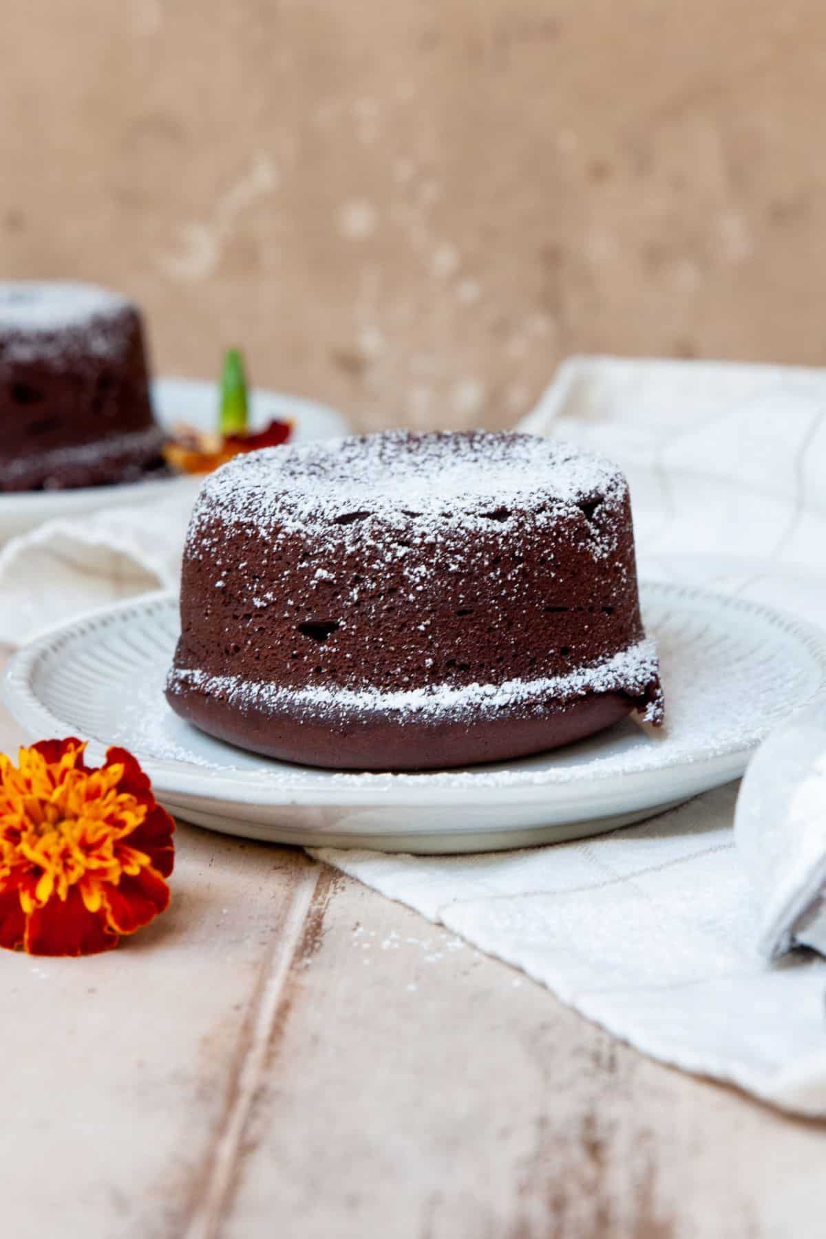 Baked vegan lava cake dusted with powdered sugar.