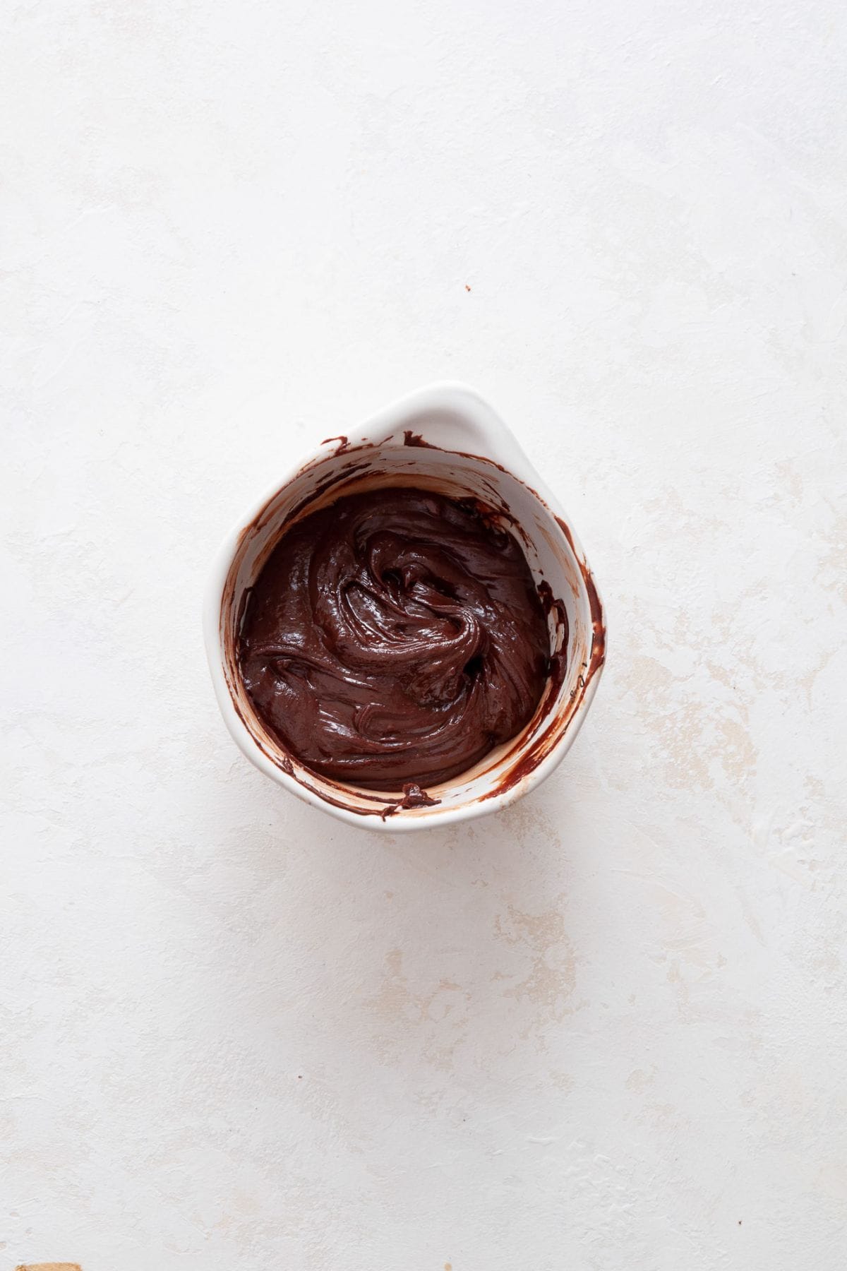 Melted dairy-free chocolate ganache in a bowl.