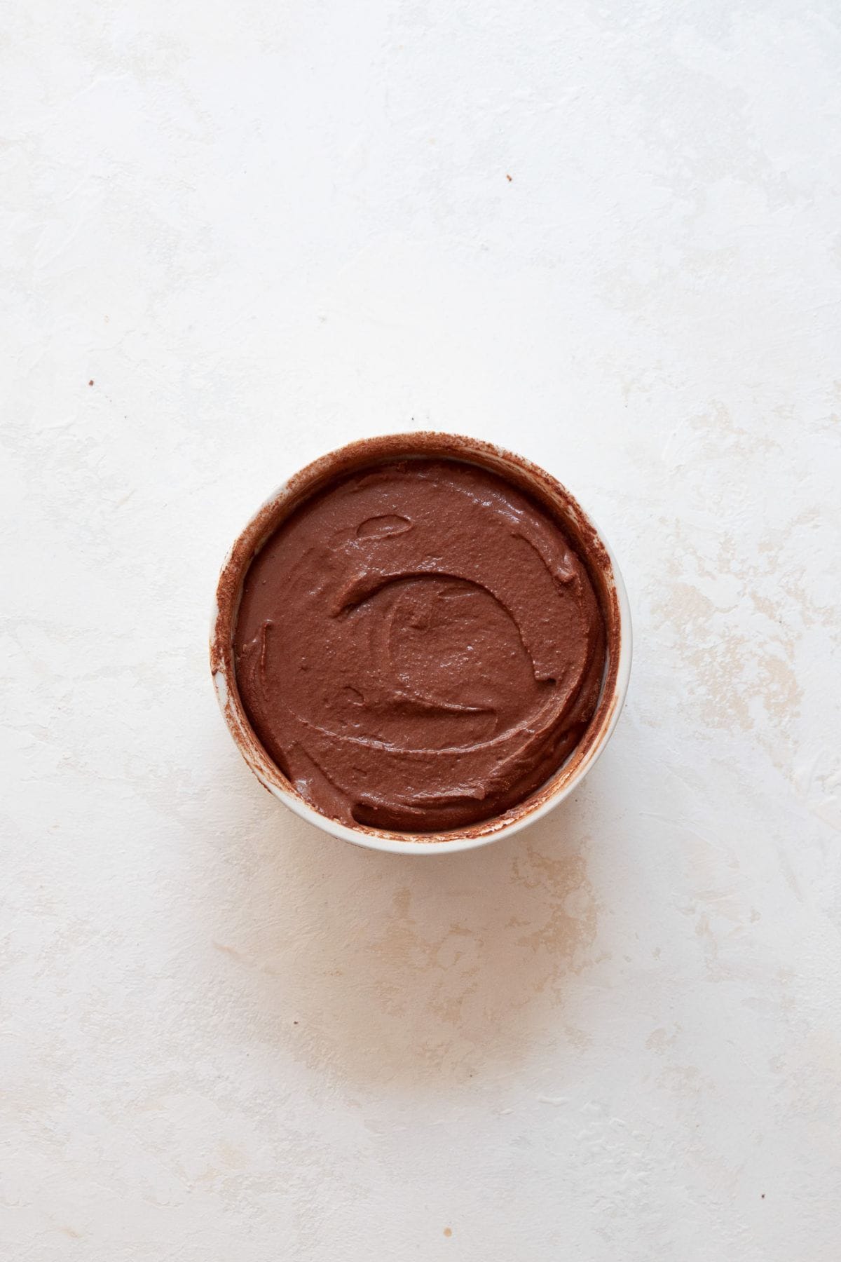 Ramekin filled with lava cake batter, ready to bake.