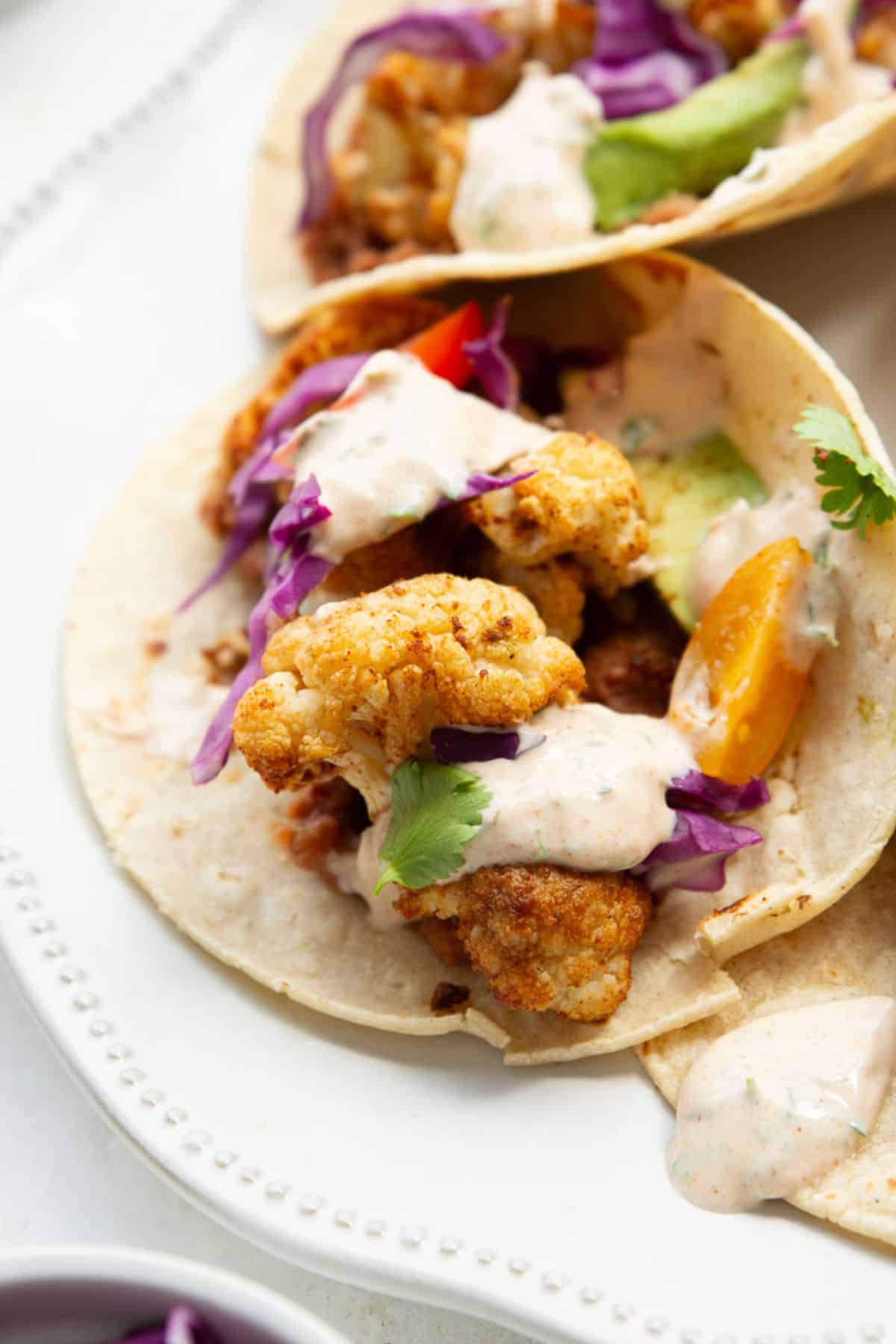 Close up of crispy spiced cauliflower inside a taco.