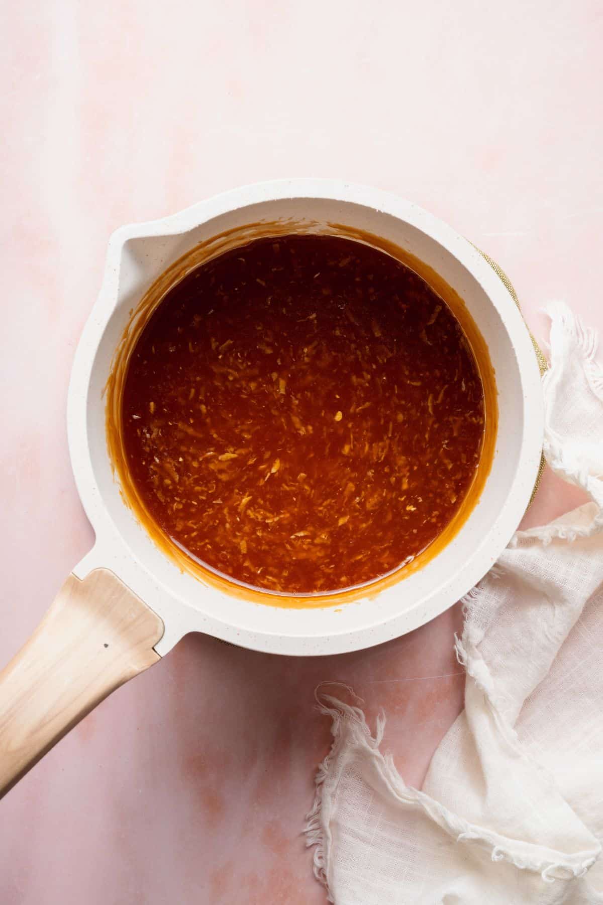 Thickened homemade teriyaki sauce with ginger and garlic in a small saucepan.