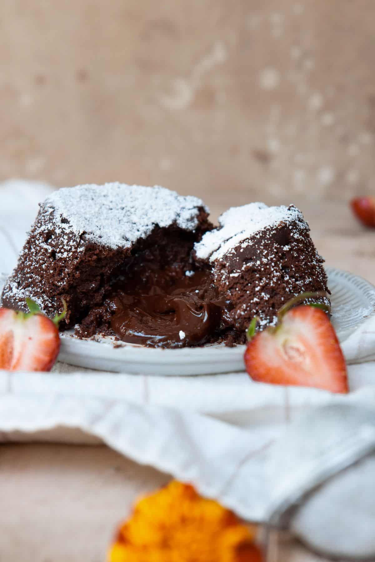 Vegan lava cake split in half showing the molten chocolate center.