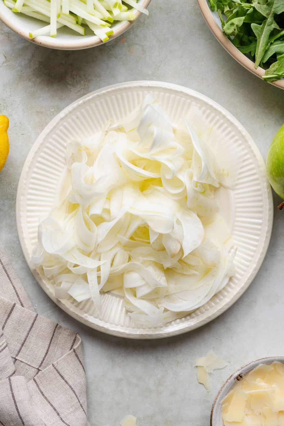 Paper-thin shaved fennel ribbons ready to add to the salad.